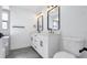 Modern bathroom with double vanity, tiled floors, and black hardware at 4907 Parson Brown Ln, Palm Harbor, FL 34684