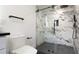 Modern bathroom featuring a walk-in shower with marble tiling and glass door at 4907 Parson Brown Ln, Palm Harbor, FL 34684