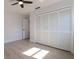 Bright bedroom featuring neutral paint, ceiling fan, closet, and plank flooring at 4907 Parson Brown Ln, Palm Harbor, FL 34684