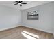 This bedroom offers natural light, neutral paint, plank flooring, and a ceiling fan at 4907 Parson Brown Ln, Palm Harbor, FL 34684