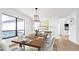 Elegant dining room with large windows and modern chandelier at 4907 Parson Brown Ln, Palm Harbor, FL 34684