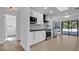Bright kitchen featuring white cabinetry, modern appliances and a light-filled breakfast nook at 4907 Parson Brown Ln, Palm Harbor, FL 34684