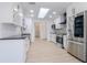 Bright kitchen with stainless steel appliances, skylight, and plenty of cabinet space at 4907 Parson Brown Ln, Palm Harbor, FL 34684