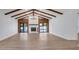 Spacious living room features a stone fireplace, vaulted ceilings, and sliding glass doors at 4907 Parson Brown Ln, Palm Harbor, FL 34684