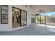 Spacious patio with modern windows leading to the kitchen, tile flooring, and ceiling fans at 4907 Parson Brown Ln, Palm Harbor, FL 34684