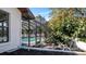 Screened in pool with lush landscaping and greenery, accessed from side of house at 4907 Parson Brown Ln, Palm Harbor, FL 34684