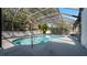 Inviting backyard pool with a screened enclosure for outdoor enjoyment at 4907 Parson Brown Ln, Palm Harbor, FL 34684