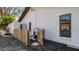 Charming fenced side yard with white stucco wall, gate, garden and window at 4907 Parson Brown Ln, Palm Harbor, FL 34684