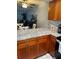 Kitchen area featuring wood cabinets, stainless steel appliances, and a bar top at 215 Valencia Blvd # 212, Belleair Bluffs, FL 33770