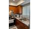 Efficient kitchen features warm cabinets, granite countertops, and modern appliances at 215 Valencia Blvd # 212, Belleair Bluffs, FL 33770