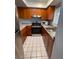 Bright kitchen featuring updated appliances, tile flooring, and granite countertops at 215 Valencia Blvd # 212, Belleair Bluffs, FL 33770