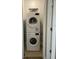 A stacked, white, front-load washer and dryer in a utility closet at 215 Valencia Blvd # 212, Belleair Bluffs, FL 33770