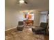 Comfortable living space with chairs, ottoman, and view into the kitchen at 215 Valencia Blvd # 212, Belleair Bluffs, FL 33770
