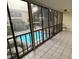 Enclosed patio with tile flooring overlooking a pool area at 215 Valencia Blvd # 212, Belleair Bluffs, FL 33770