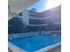 Relaxing community pool with chairs and a view of the building at 215 Valencia Blvd # 212, Belleair Bluffs, FL 33770