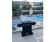 Grilling area with a modern Nexgrill near the community swimming pool at 215 Valencia Blvd # 212, Belleair Bluffs, FL 33770