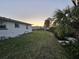 A sprawling green backyard with lush grass and privacy landscaping offering a tranquil outdoor space at 460 Creek Lane Dr, Englewood, FL 34223