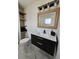 Tastefully renovated bathroom with floating vanity, stylish mirror, and modern fixtures on marble tile floor at 460 Creek Lane Dr, Englewood, FL 34223