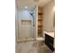 Contemporary bathroom with walk-in shower, stylish floating shelves, and modern fixtures at 460 Creek Lane Dr, Englewood, FL 34223