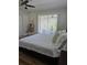 Primary bedroom with wood flooring and access to the outdoor screened in porch, natural light and views at 460 Creek Lane Dr, Englewood, FL 34223