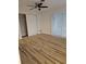 Bright bedroom with wood floors, ceiling fan, closet, and sliding glass doors to let the sun shine in at 460 Creek Lane Dr, Englewood, FL 34223