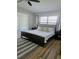 Primary bedroom with wood flooring, a ceiling fan, and sliding doors to the patio at 460 Creek Lane Dr, Englewood, FL 34223