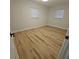 Bedroom features wood flooring and bright windows, creating a warm atmosphere at 460 Creek Lane Dr, Englewood, FL 34223