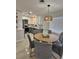 Bright dining area featuring a round table and modern lighting next to the remodeled kitchen at 460 Creek Lane Dr, Englewood, FL 34223