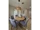 Inviting dining room featuring a round table with seating for six and an eye-catching wicker light fixture at 460 Creek Lane Dr, Englewood, FL 34223