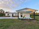 Welcoming single-story home featuring fresh white paint, black accents, and green yard at 460 Creek Lane Dr, Englewood, FL 34223