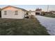 Charming exterior with well-maintained landscaping and a gravel driveway leading to the carport at 460 Creek Lane Dr, Englewood, FL 34223