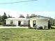 Charming single-story home featuring fresh white paint, black accents, and green yard at 460 Creek Lane Dr, Englewood, FL 34223