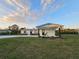 Inviting single-story home featuring fresh white paint, black accents, and green yard at 460 Creek Lane Dr, Englewood, FL 34223