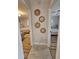 Hallway with tan tile flooring leading to bedrooms with beautiful wood flooring and neutral color schemes at 460 Creek Lane Dr, Englewood, FL 34223