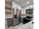Well-lit kitchen showcasing stainless steel refrigerator, oven, and stylish countertops at 460 Creek Lane Dr, Englewood, FL 34223
