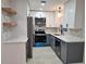 Updated kitchen features modern stainless steel appliances and white and gray cabinetry at 460 Creek Lane Dr, Englewood, FL 34223