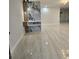 Bright living room featuring an artistic accent wall and new tile flooring throughout at 460 Creek Lane Dr, Englewood, FL 34223