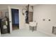 Functional utility room with a water heater, furnace, and a utility sink for added convenience at 460 Creek Lane Dr, Englewood, FL 34223