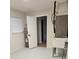 The utility room has a sink, water heater, and a door leading to another room with light streaming through its window at 460 Creek Lane Dr, Englewood, FL 34223