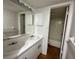 Bathroom featuring double sinks, white cabinets, and a shower/bath combo at 7522 Needle Leaf Pl # 27, Tampa, FL 33617