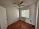Bedroom featuring wood floors, a window with blinds and a ceiling fan with lights at 7522 Needle Leaf Pl # 27, Tampa, FL 33617