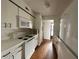 Kitchen featuring white cabinets and appliances, wood floors and an open view of the home at 7522 Needle Leaf Pl # 27, Tampa, FL 33617