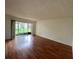 Living room featuring wood floors and sliding glass doors leading to a patio at 7522 Needle Leaf Pl # 27, Tampa, FL 33617