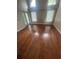 Bedroom with hardwood floors, a vaulted ceiling, and ample natural light from large windows at 7139 Colony Pointe Dr, Riverview, FL 33578