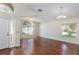 Bright living room with hardwood floors, large windows, and a high ceiling for a spacious feel at 7139 Colony Pointe Dr, Riverview, FL 33578