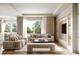 Spacious living room featuring modern decor, large windows, and neutral-colored couches at 125 Baytree Dr, Rotonda West, FL 33947