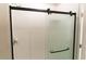 Modern bathroom with a glass shower sliding door and white tile at 7316 Samuel Ivy Dr, Tampa, FL 33619