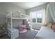 Charming bedroom featuring a lofted bed, complemented by abundant natural light and a cozy rug at 8292 Shooting Star Rd, Sarasota, FL 34241