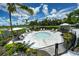 Relaxing hot tub area surrounded by lush landscaping and lounge chairs at 8292 Shooting Star Rd, Sarasota, FL 34241