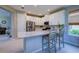Bright open kitchen with stainless steel appliances, a large island, and white cabinetry at 8292 Shooting Star Rd, Sarasota, FL 34241